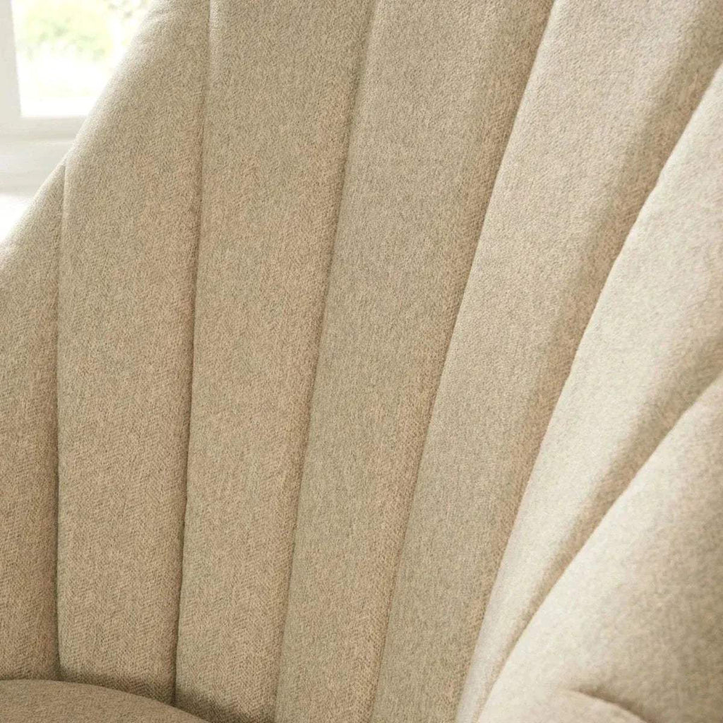 Stone fabric rocking chair backrest detail with vertical channel stitching.