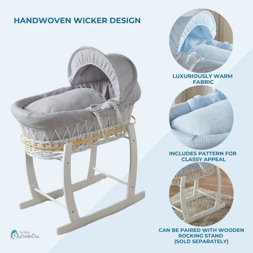 Light blue wicker baby moses basket on white stand with padded hood bedding