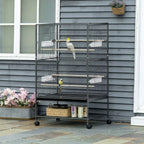 Dark grey bird cage on rolling stand with small perches and two budgies inside