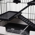 Inside view of three-tier metal hutch with black platforms, ramp steps, and wire walls