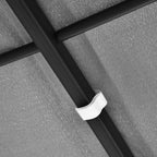 Close-up of grey fabric canopy seam with black metal frame bar and white fastener.