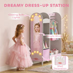 Pink kids dress-up wardrobe with arched mirror, glowing lights, and hanging clothes rod.