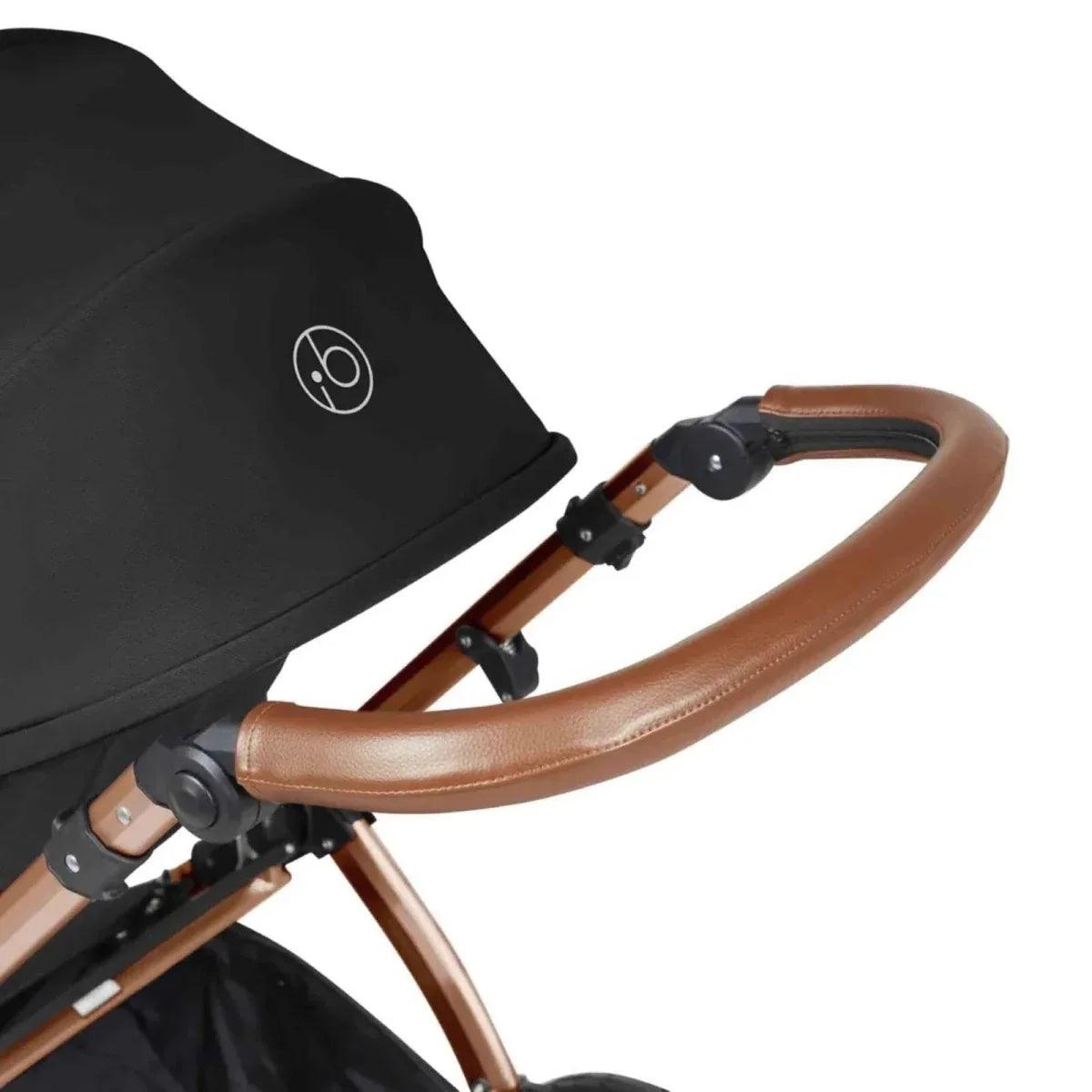 Stroller handlebar with tan leather grip and black frame detail