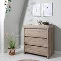 Oak changing unit with three drawers and flat top, rectangular cabinet design.