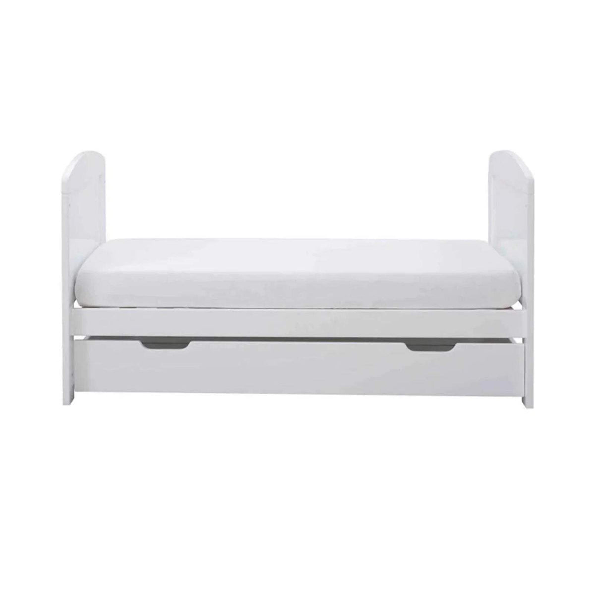 White mini cot bed with mattress and under-drawer panel, side view