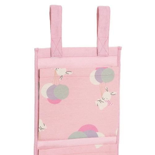Pink fabric hanging organizer with two top handles and animal-and-balloon front pocket