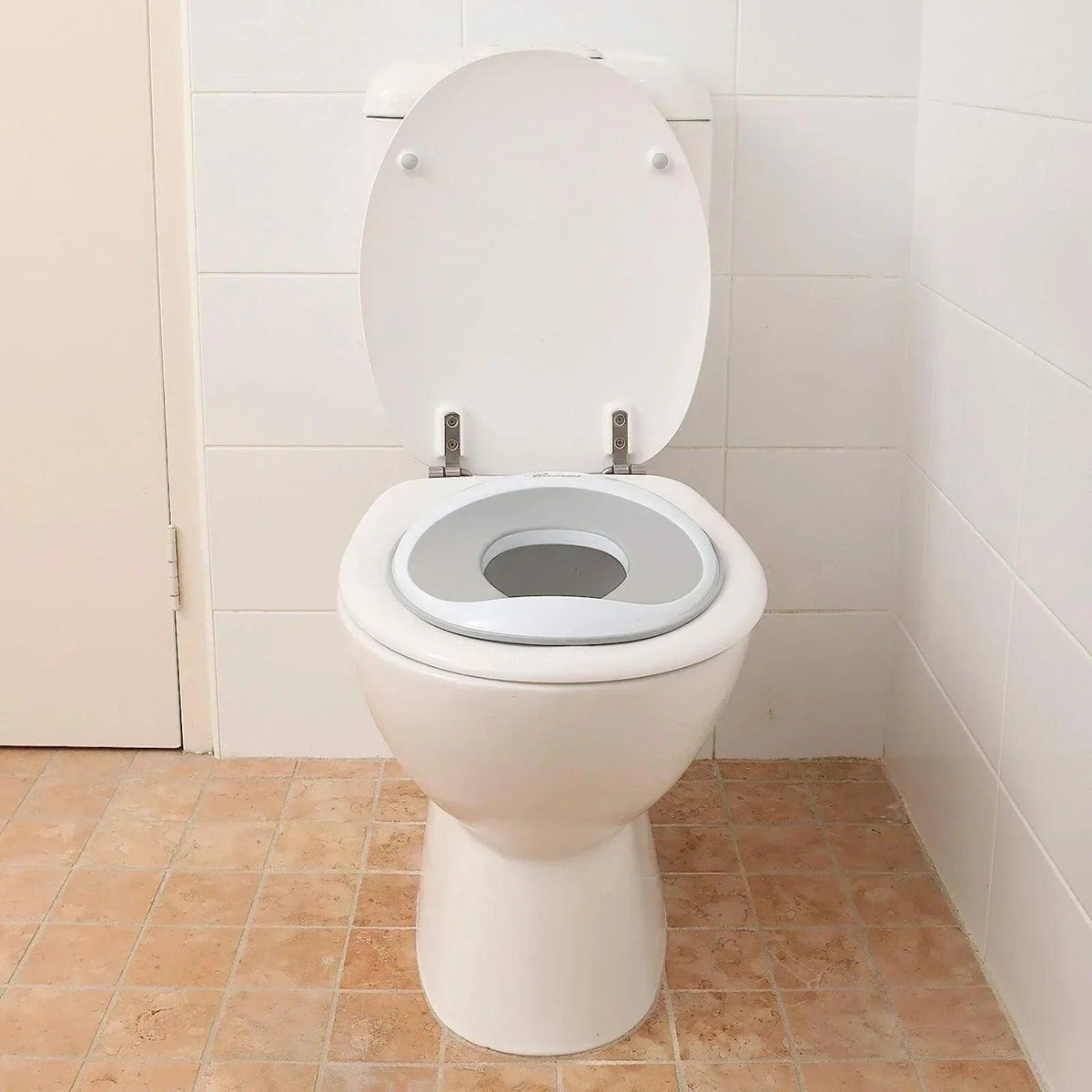 White toilet trainer seat topper on a standard toilet with oval opening