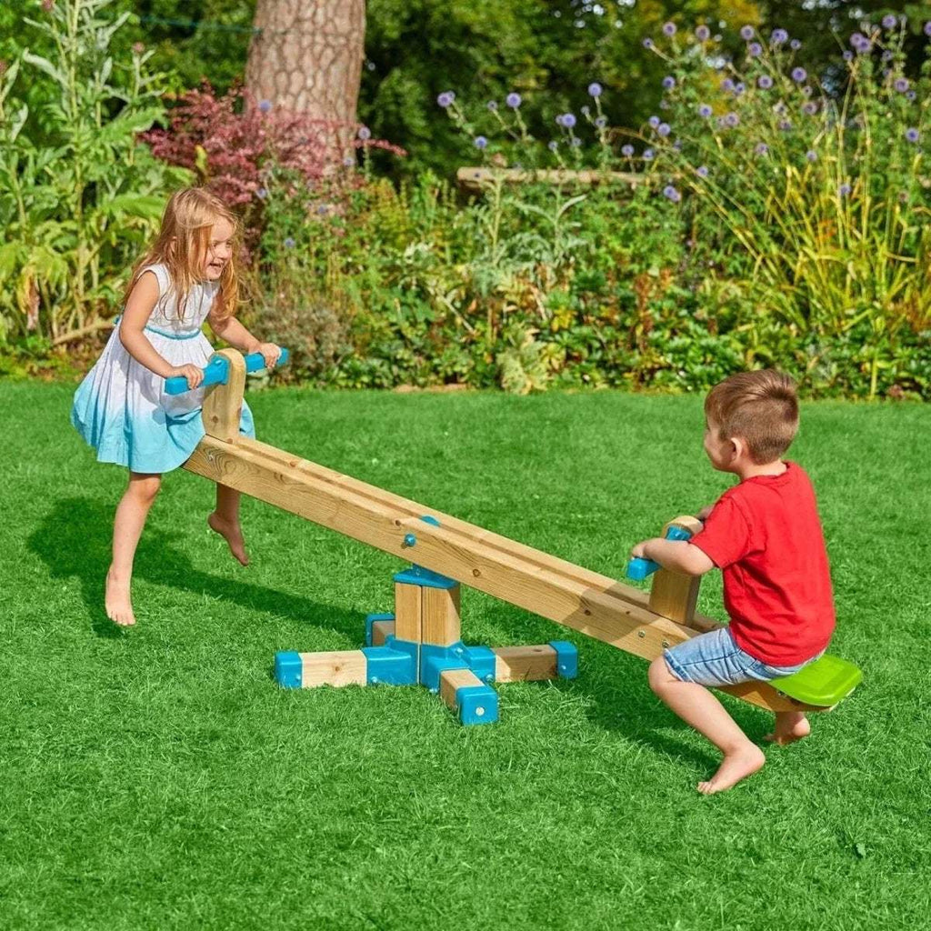 Wooden seesaw toy with blue supports and green seats, children playing outdoors
