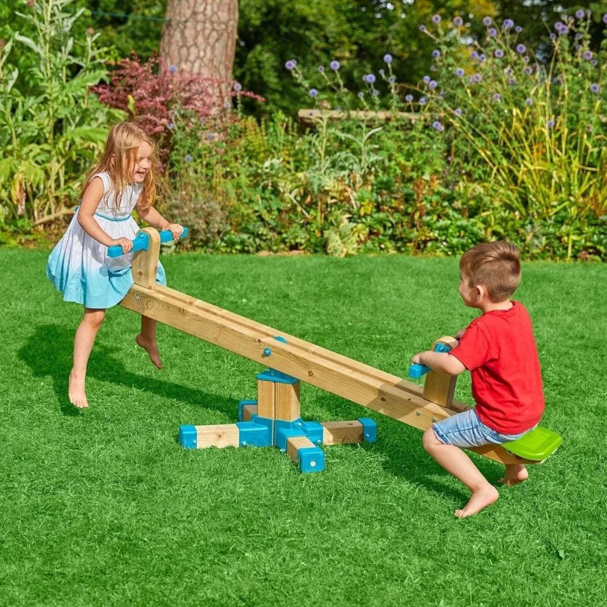Wooden seesaw toy with blue supports and green seats, children playing outdoors
