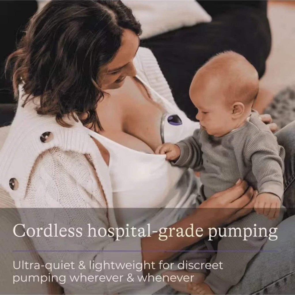 Cordless wearable breast pump attached to a nursing bra, showing white control dome