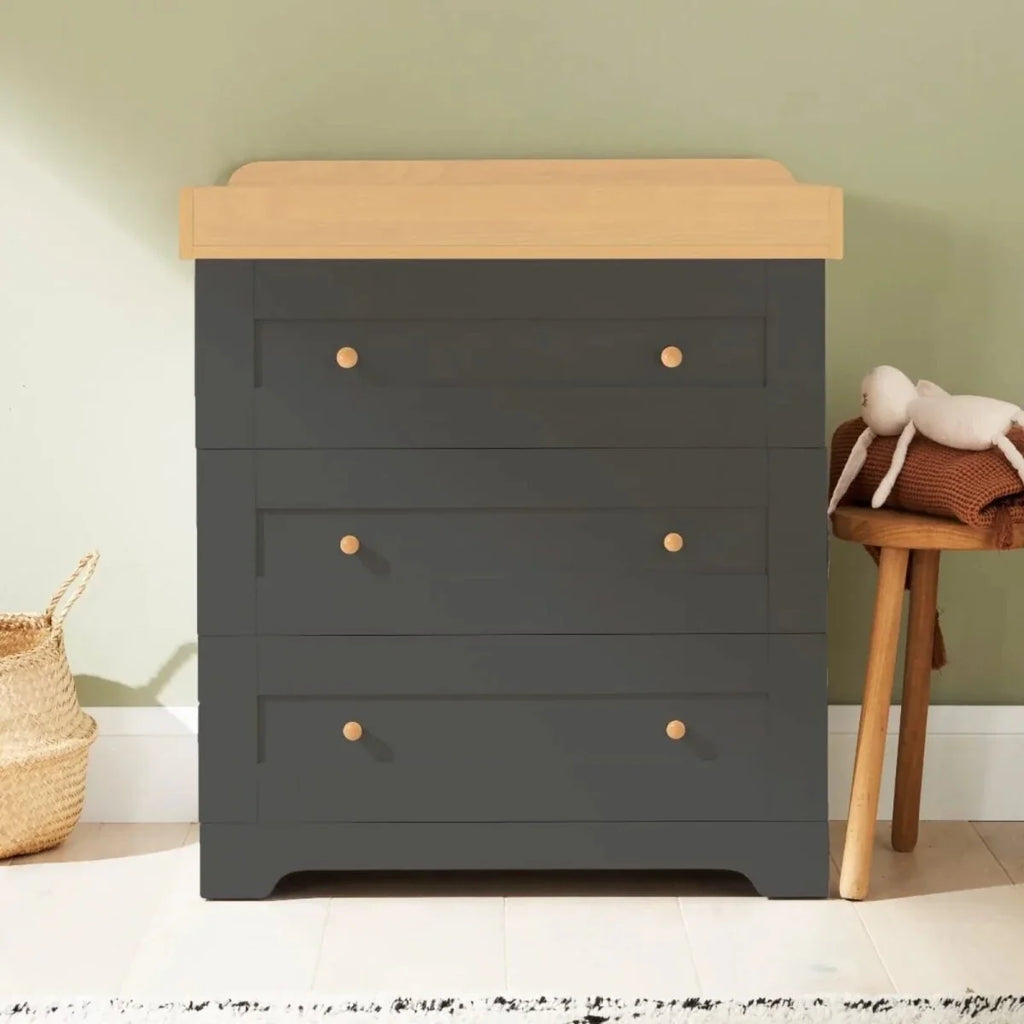 Dark gray dresser with honey oak top, three drawers and round brass-style knobs