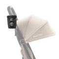Black cup holder with T logo, mounted on stroller handle