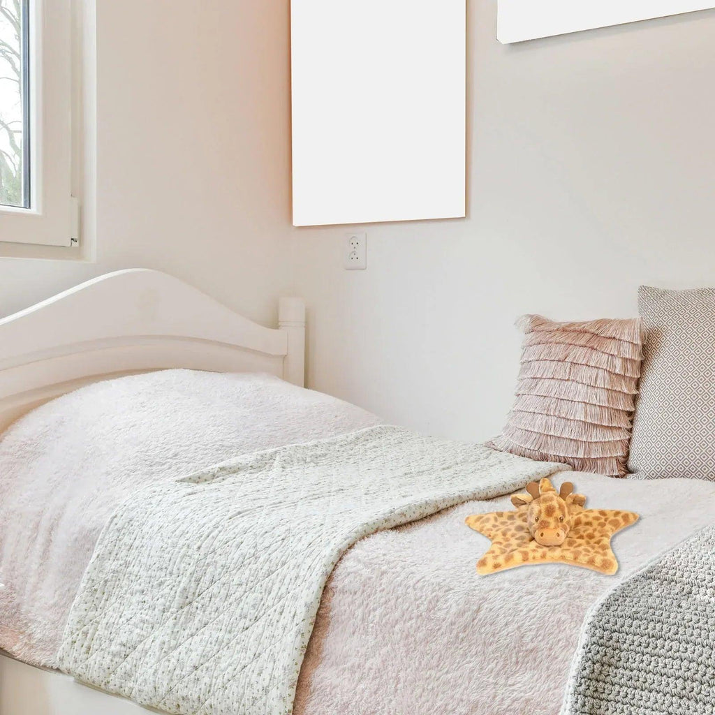 Star-shaped giraffe blanket on bed, tan and brown spotted plush with head