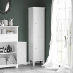 White tall bathroom storage cabinet standing beside vanity; double-door design visible