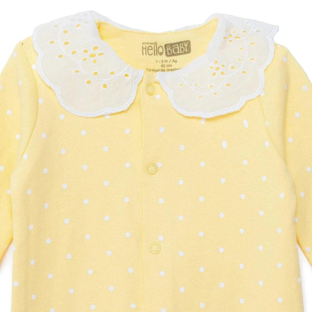 Yellow polka-dot baby sleepsuit with white scalloped collar and button placket