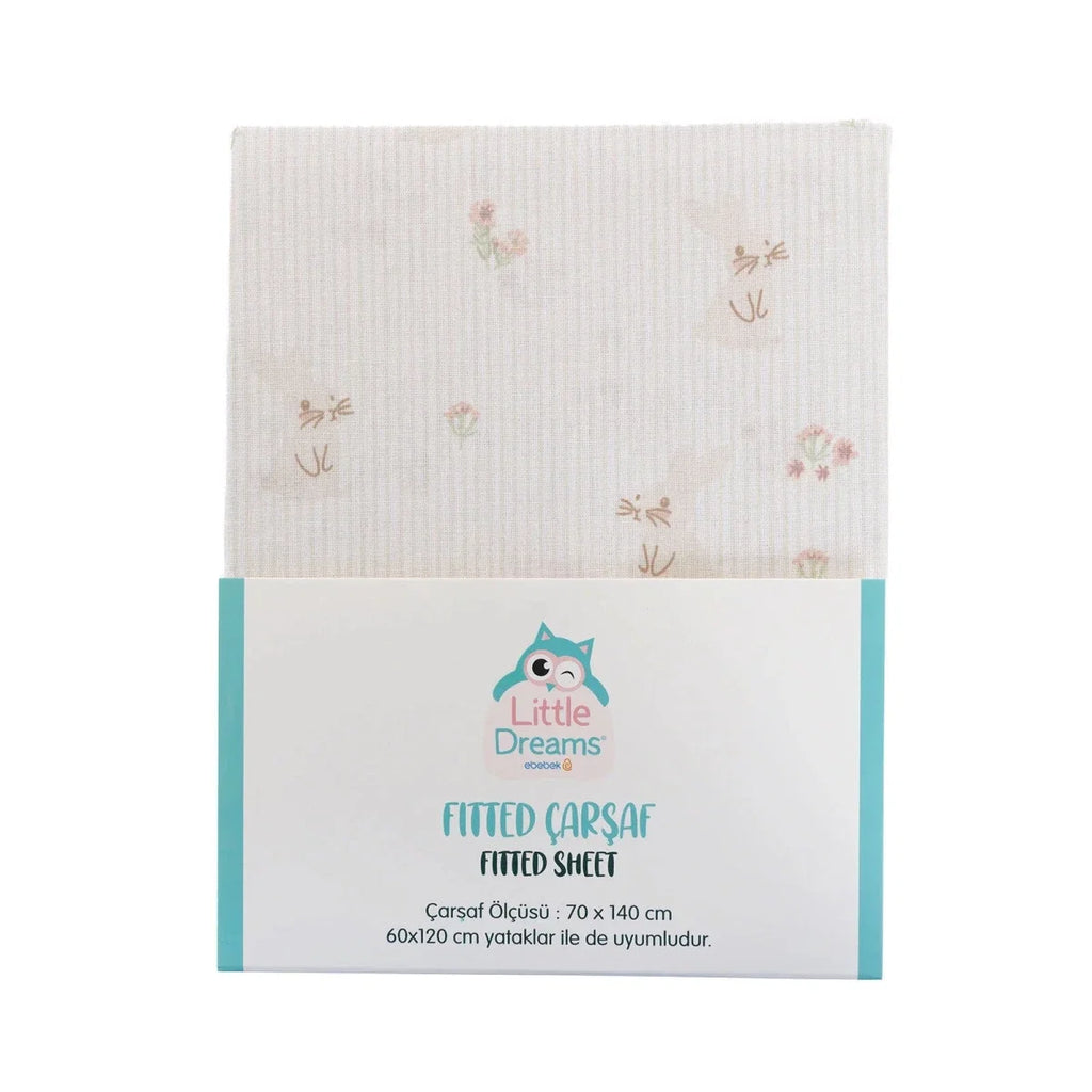Packaged Little Dreams fitted sheet in white with small pastel floral pattern