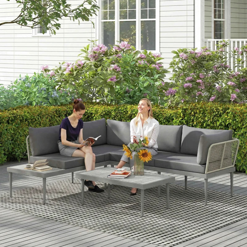 Grey outdoor rattan L-shape sofa set with cushioned chairs and coffee table