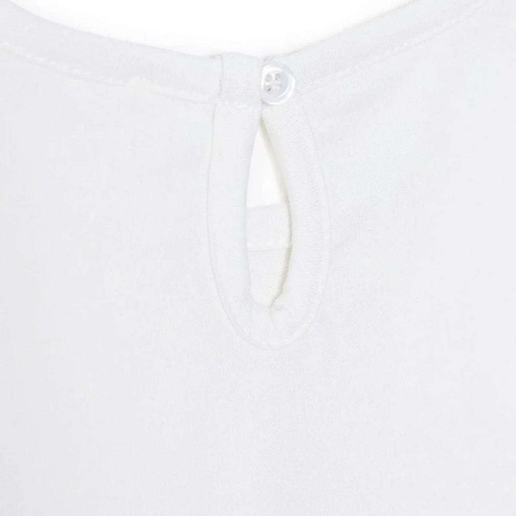 Off-white blouse with buttoned keyhole neckline and hidden placket.