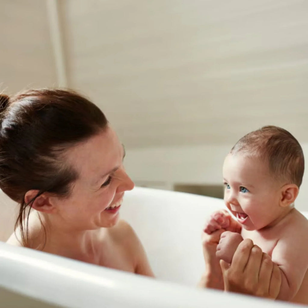 Woman washing baby in a bathtub, suitable for sensitive skin