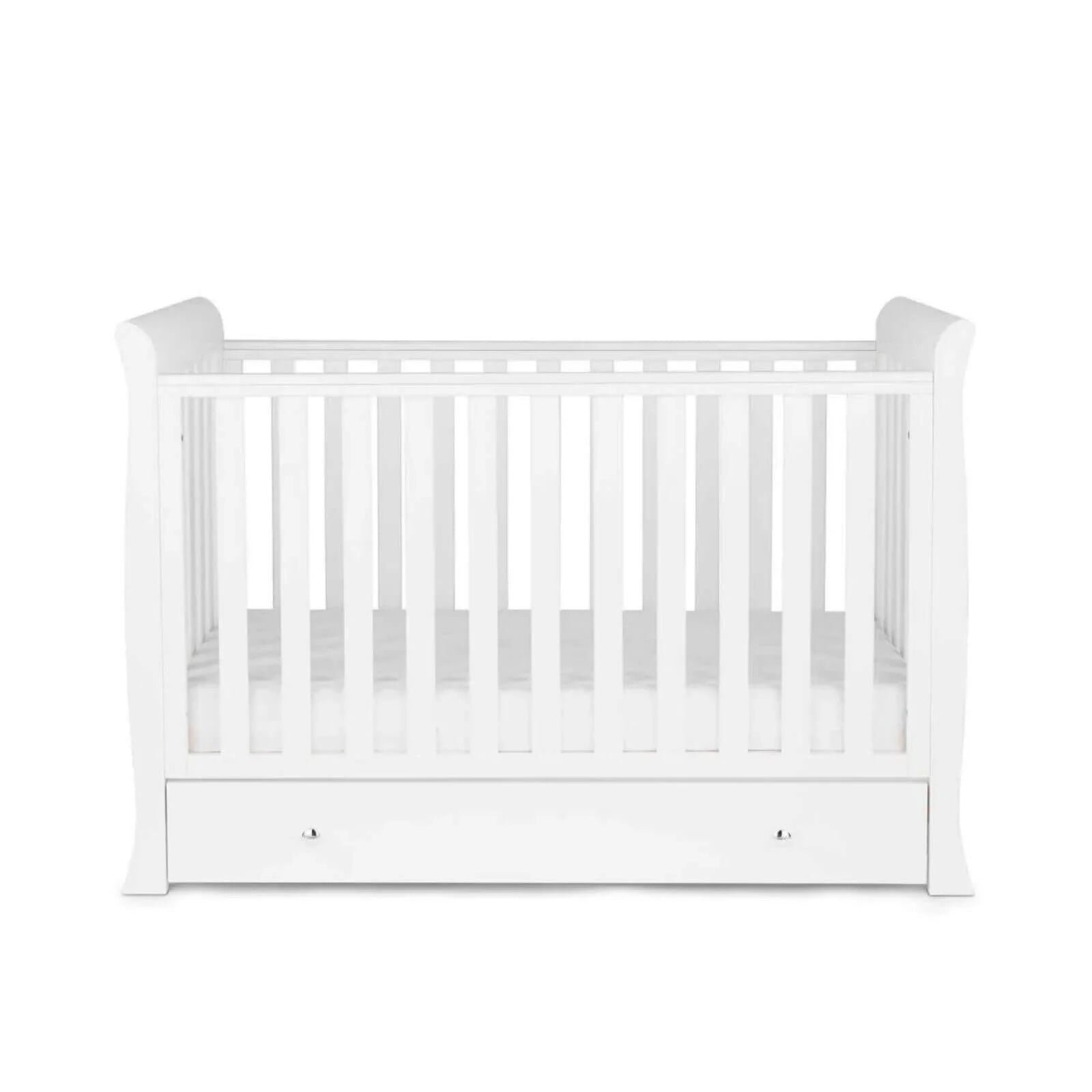 White mini cot with slatted sides and built-in drawer
