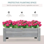 Grey raised garden planter box filled with pink flowering plants