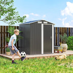 Grey metal storage shed with sliding door closed on wooden platform in a garden