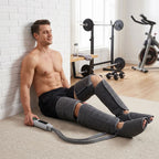 Grey leg and foot compression massager worn on calves, with control unit connected