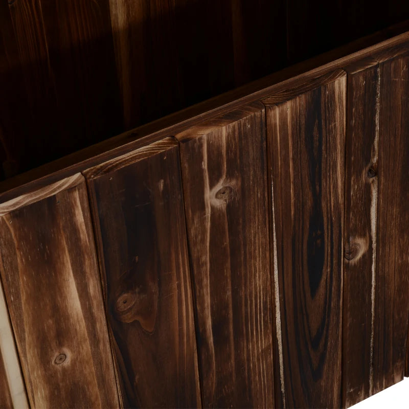 Close-up of dark carbonized wooden side boards on a raised garden bed