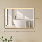 Gold-tone rectangular bathroom mirror with warm LED frame; 100 x 70 cm size shown.