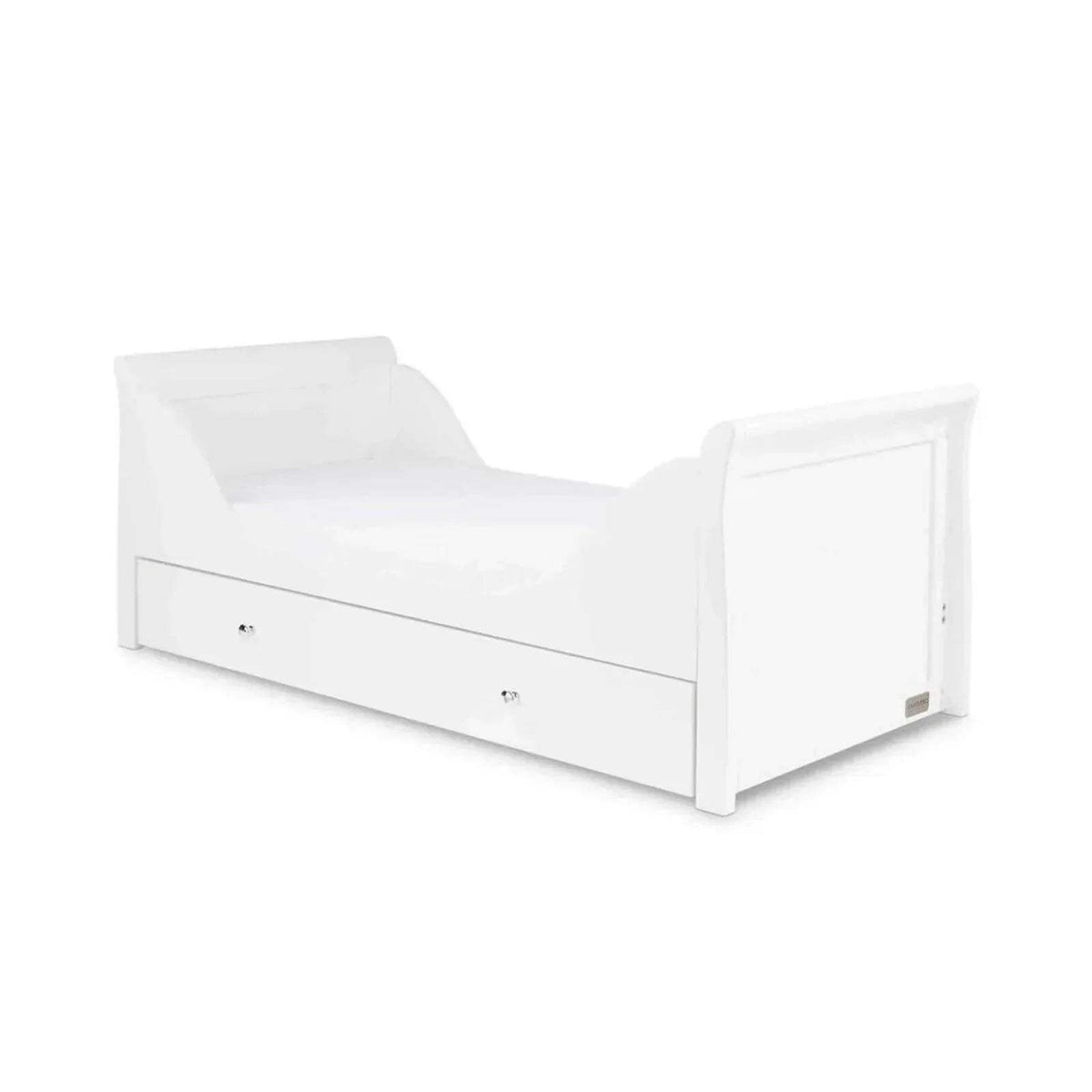 White cot bed with side panels, low front rail, and drawer storage