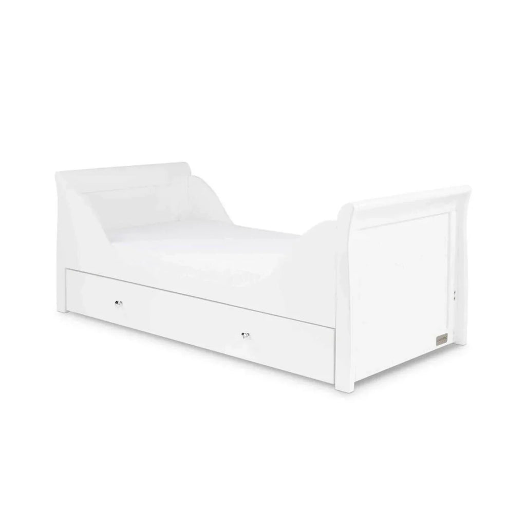 White toddler bed frame with panel sides and built-in drawer fronts, front view