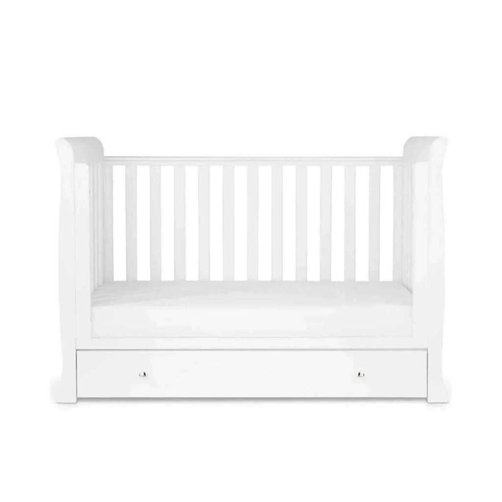White toddler bed with slatted rails and front drawer panel, empty mattress area