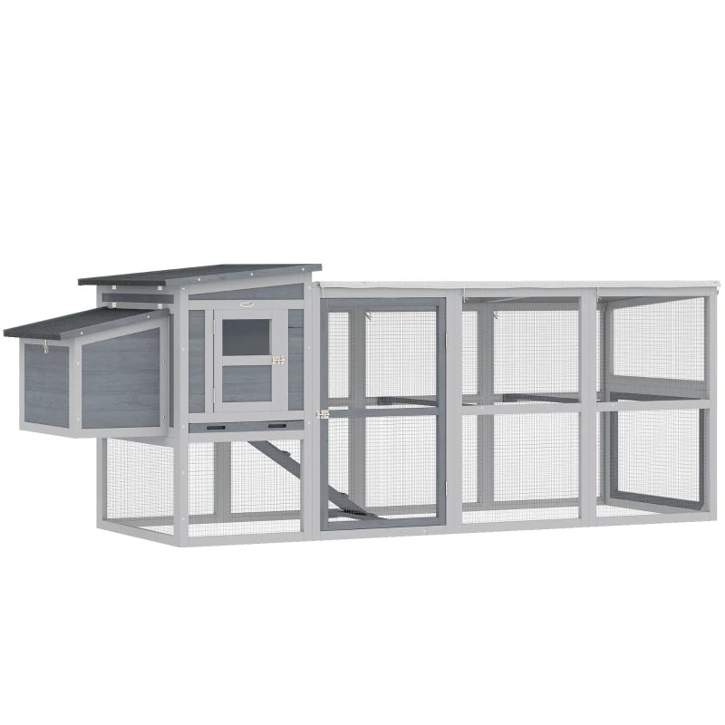 Grey wooden chicken coop with covered run, wire mesh walls, and asphalt roof