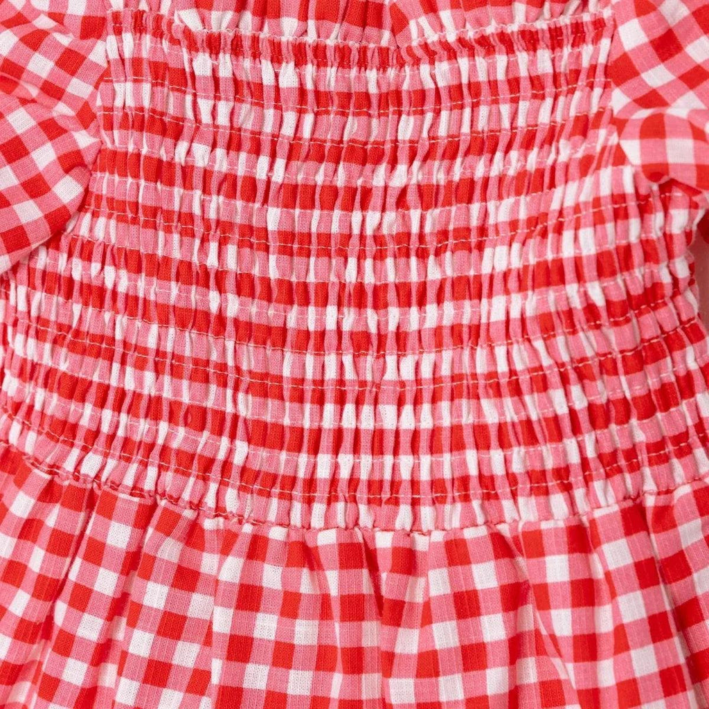Pink gingham baby dress close-up of smocked tiered bodice with elastic ruching