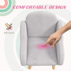 Grey kids armchair with cushioned seat and armrests, hands testing
