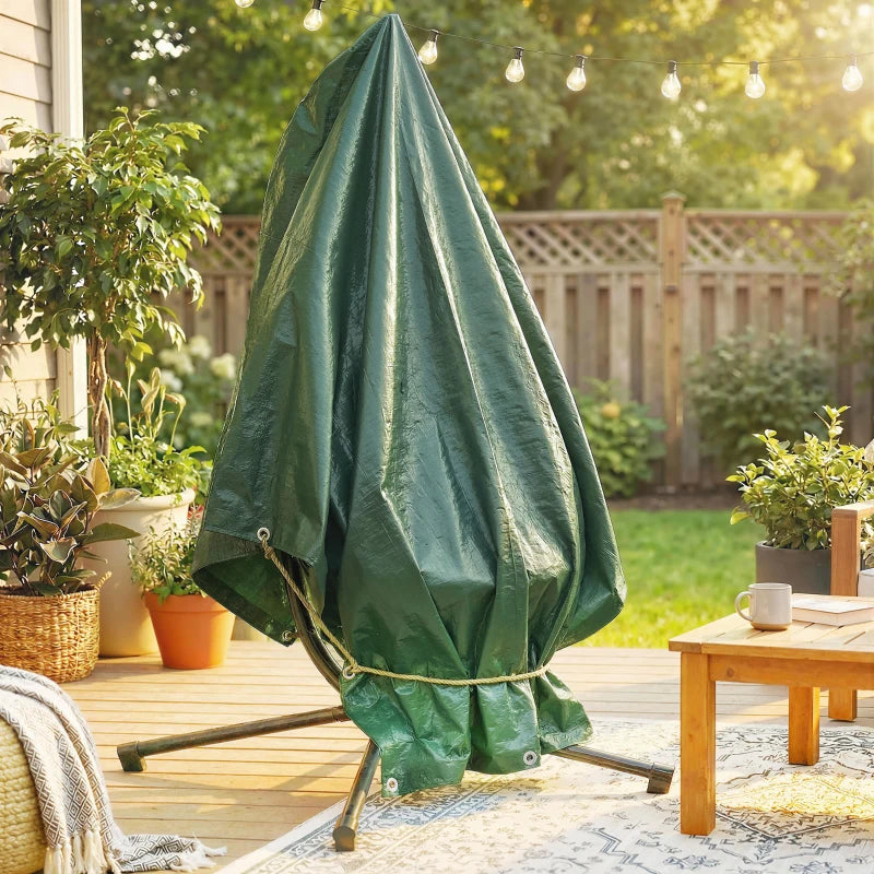 Green waterproof tarpaulin canopy draped over patio table with grommets