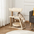 Cat climbing on light brown cat tree tower with U perch, round bed, and toy balls
