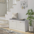 White entryway shoe storage bench with gray cushion and two flip doors