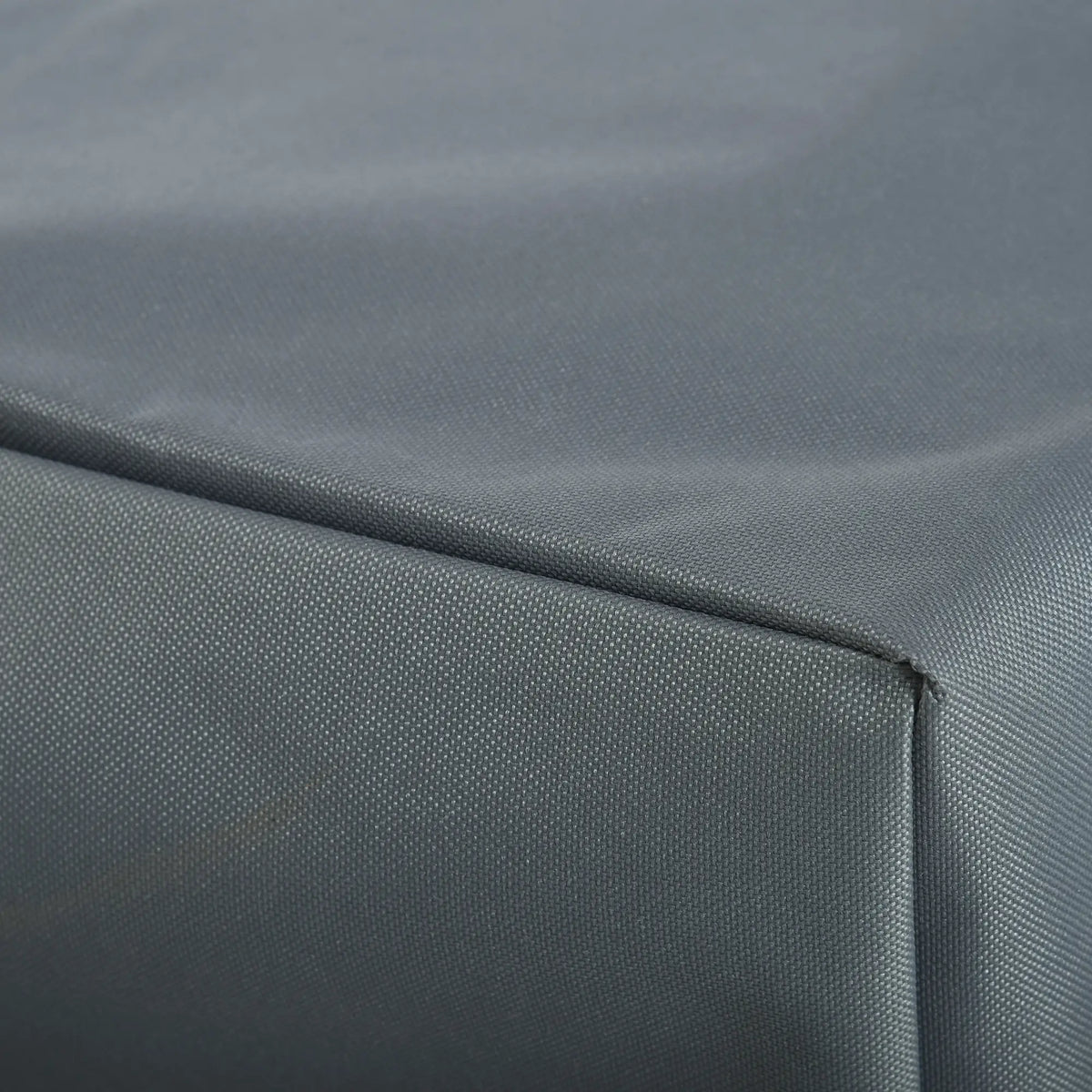 Close-up of stitched seams and woven gray cover fabric