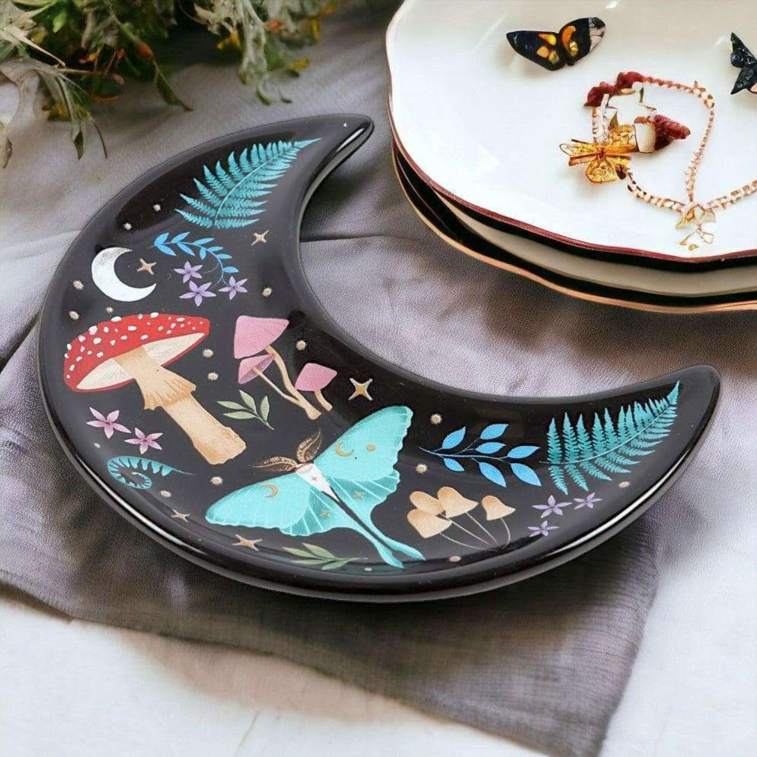 Decorative plate with fairy and mushroom design on a gray surface