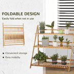 Foldable bamboo plant stand with three slatted tiers, shown with potted plants