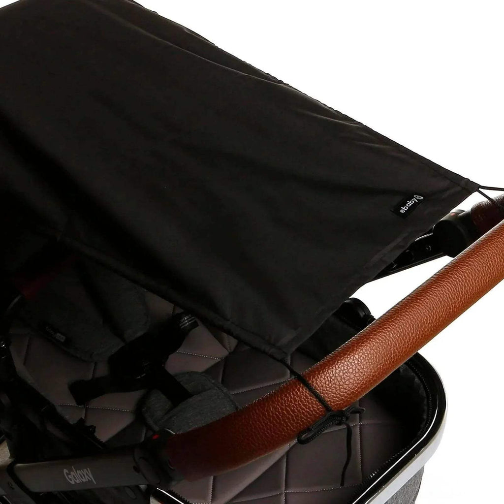 Black stroller sunshade canopy fabric with stitched seams and attachment ties