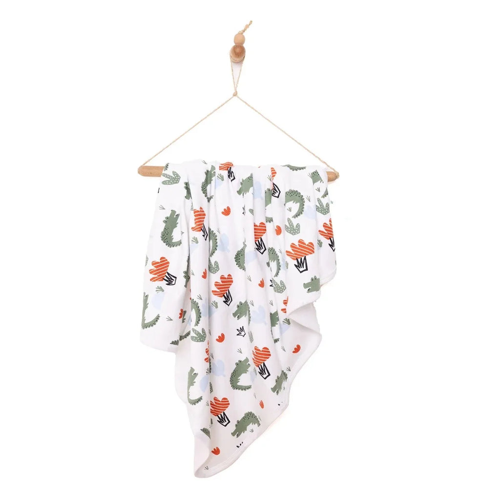 Cactus-print kids blanket draped with repeating arrow and heart patterns