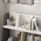 Grey kids storage shelf with white compartments holding books, toys, and a teddy