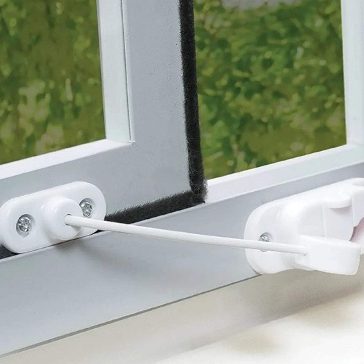 White window restrictor latch with cable on window frame, secured with screws