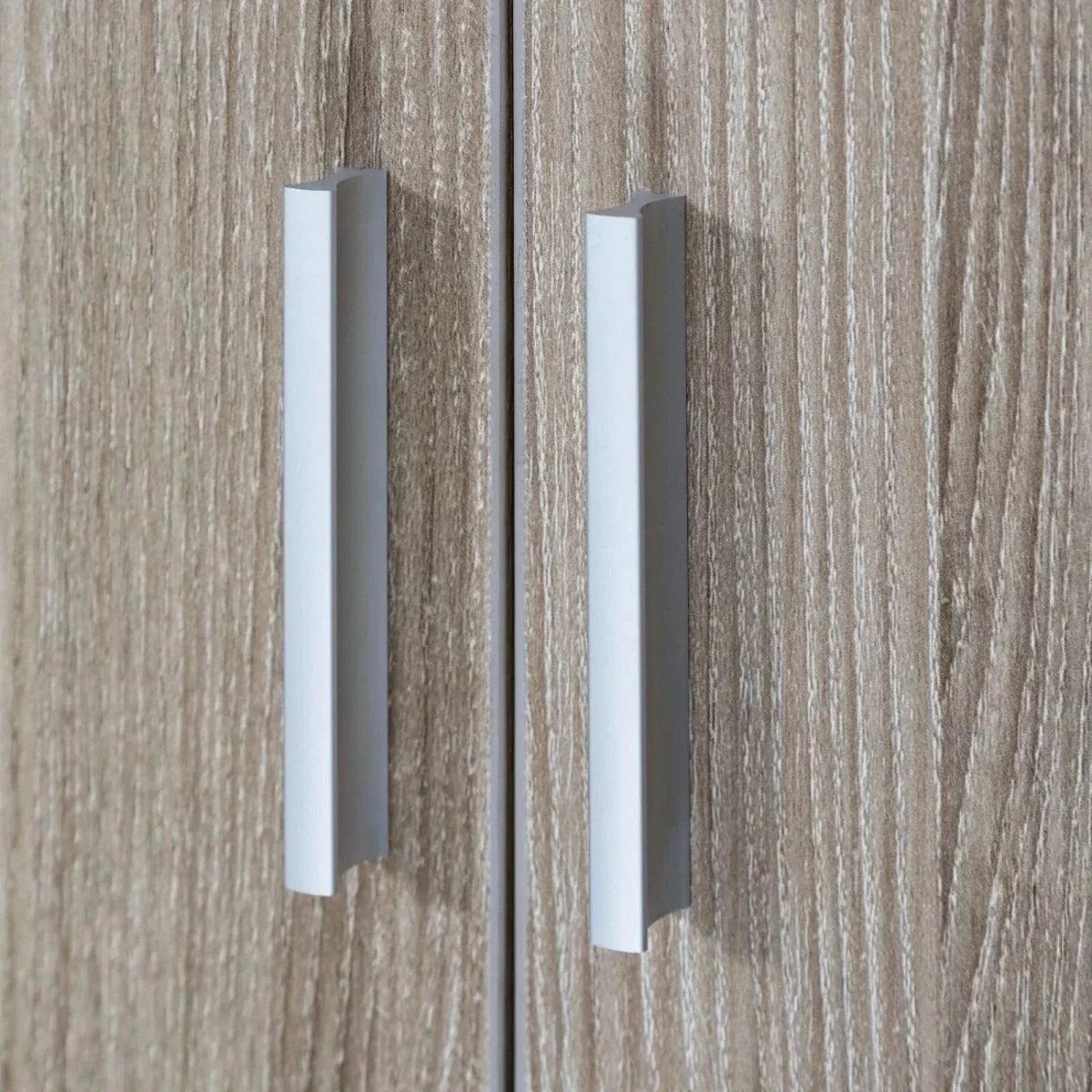 Close-up of slim silver bar handles on an oak wardrobe double-door front