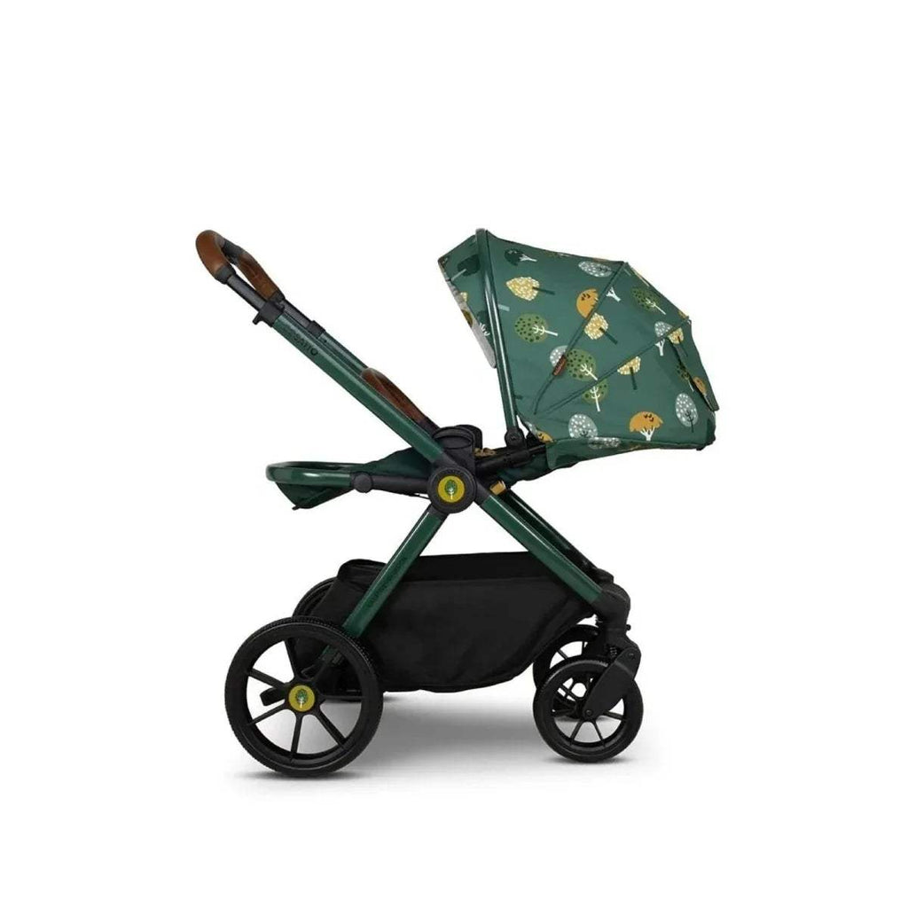 Green pushchair with patterned canopy and black under-seat basket, angled side view