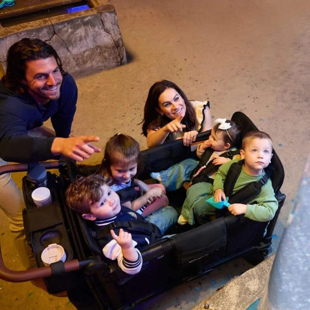 Jet black stroller wagon with open seating for four children