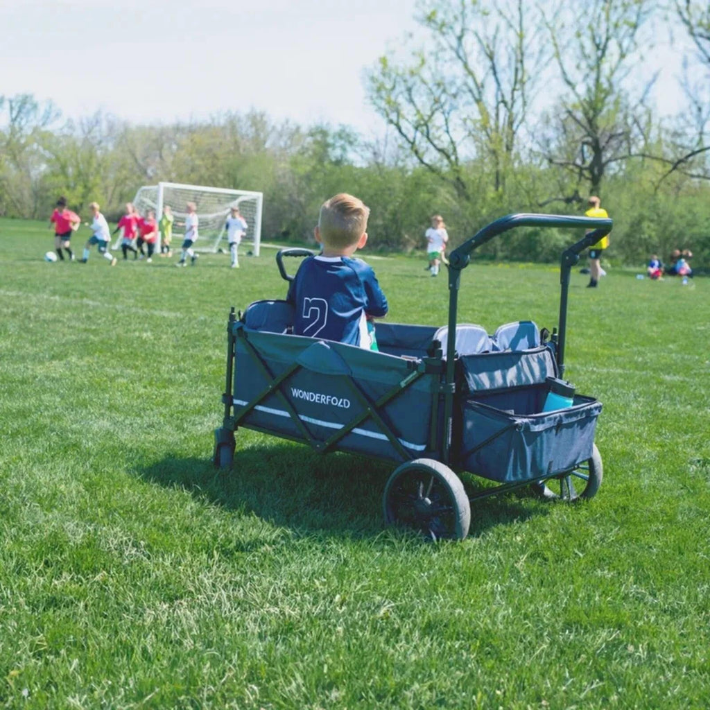 Black Wonderfold X4R quad stroller wagon with canopy, seating area, and front storage