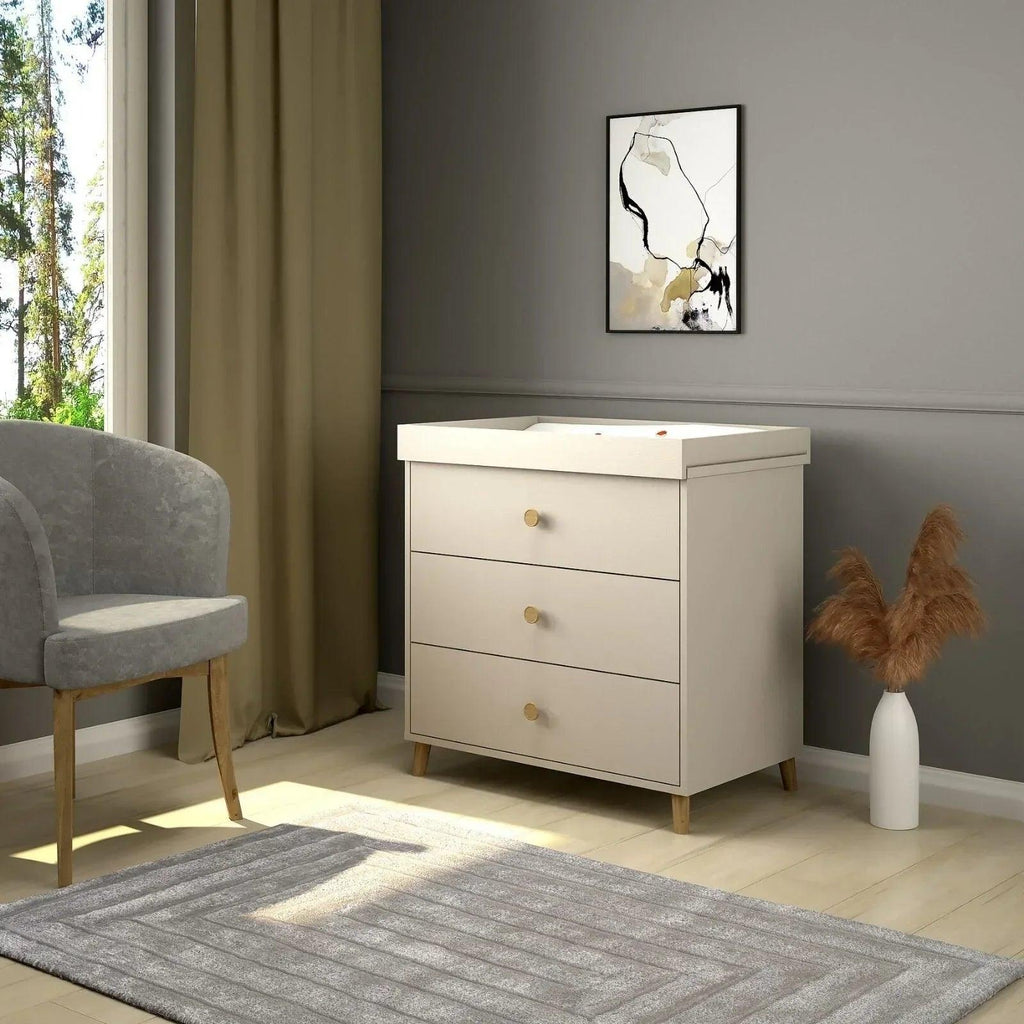 Kids changing dresser with three drawers in cashmere beige and round brass knob pulls